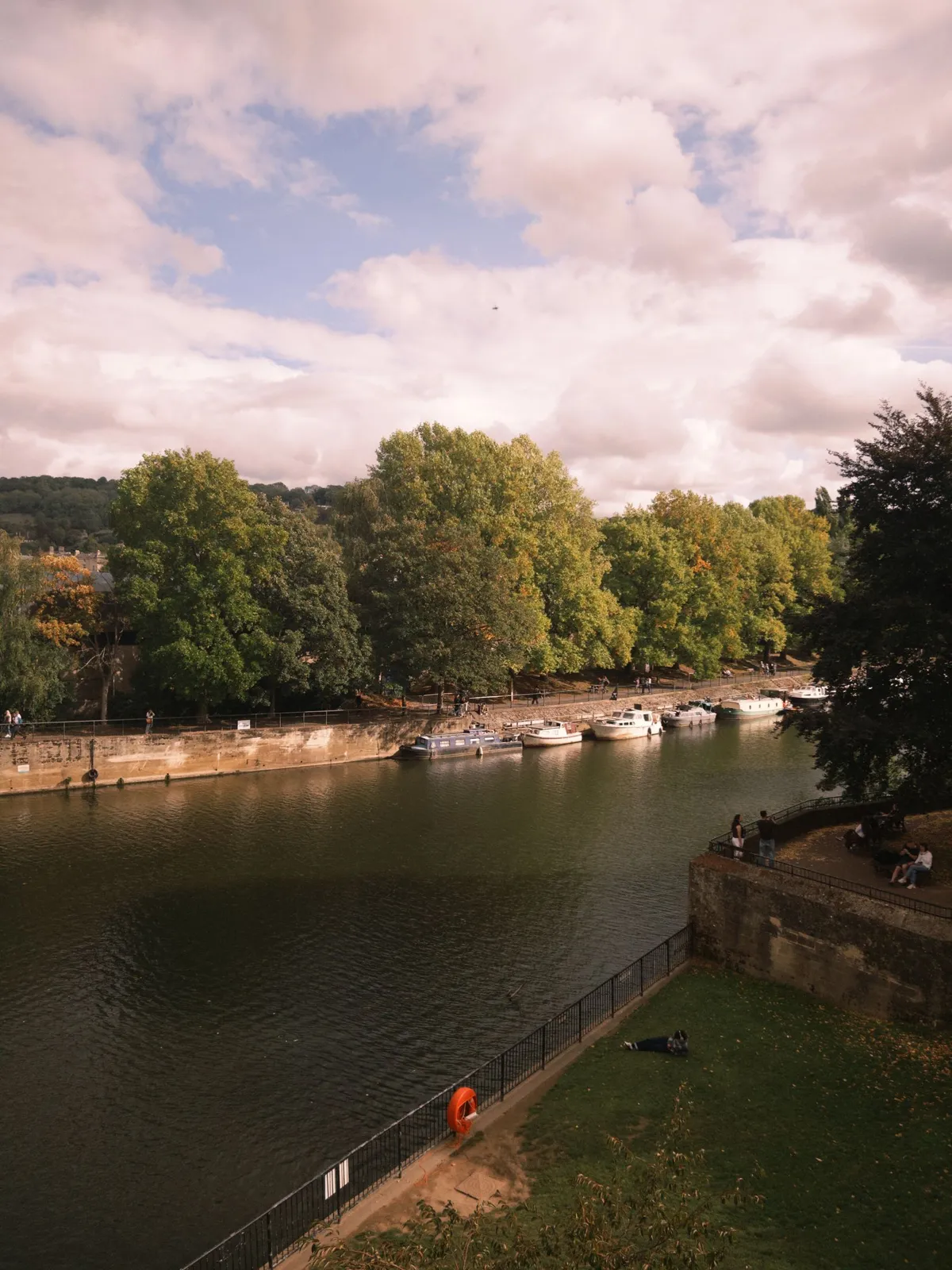 Boats and green banks along the River Avon in Bath
