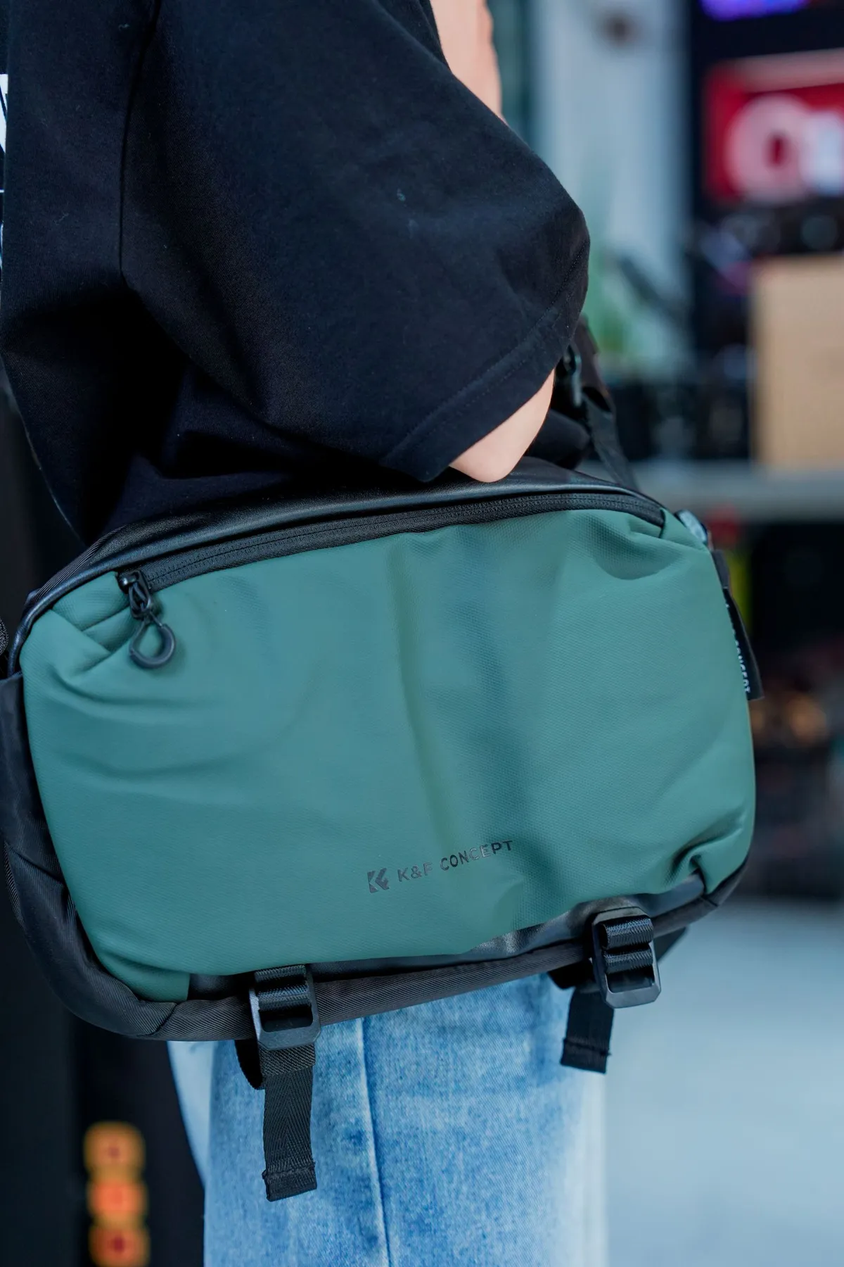 Green messenger bag worn across the body