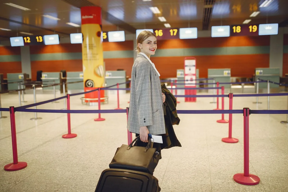 Traveler with a suitcase approaching airport check-in