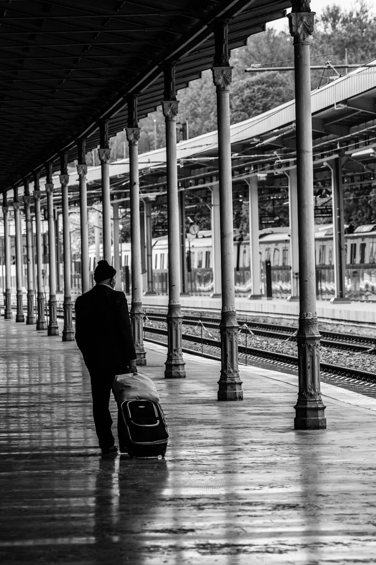 Traveler with a suitcase at a railway platform