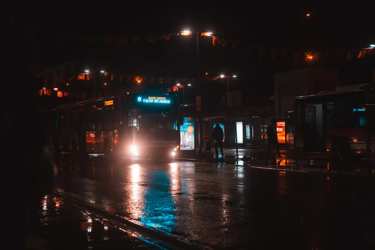 City bus beside a stop at night