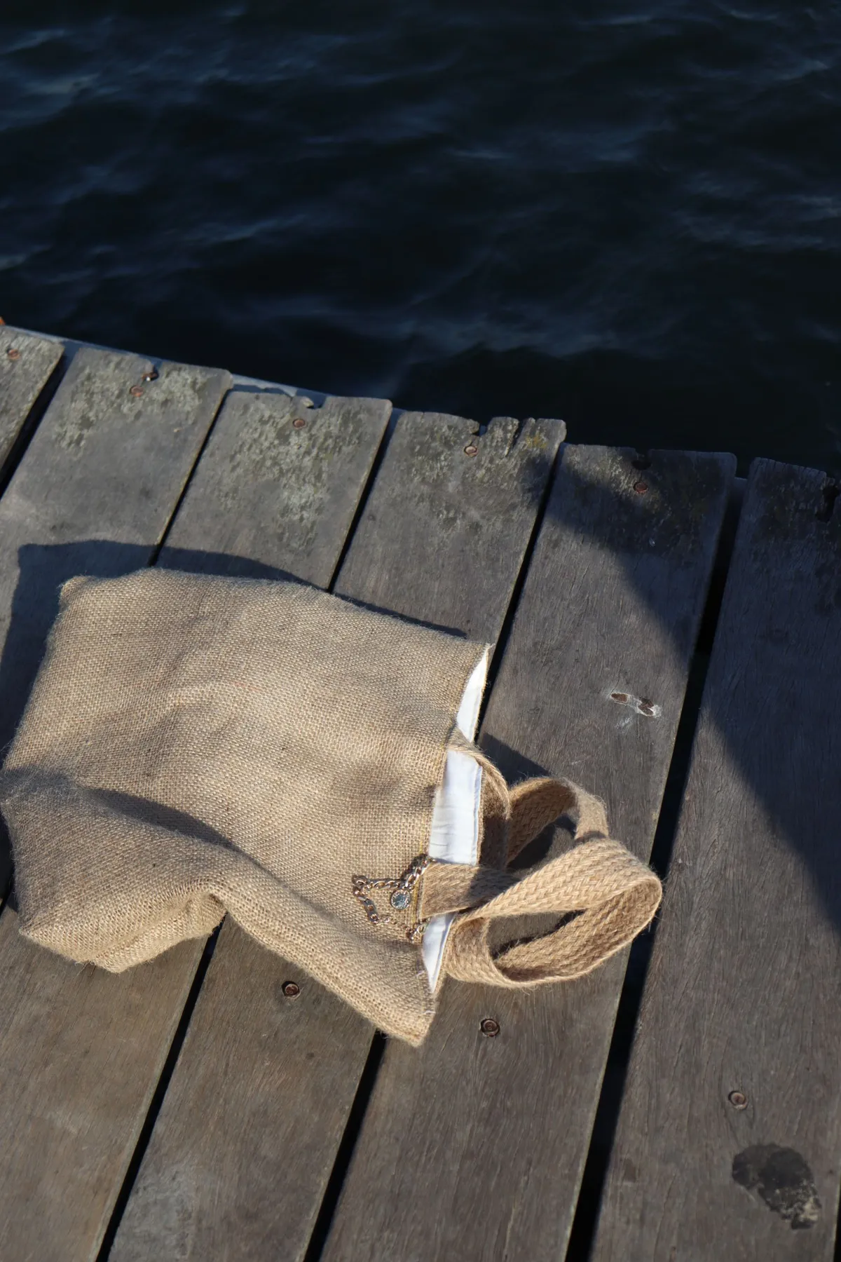 A canvas tote bag on a wooden boardwalk