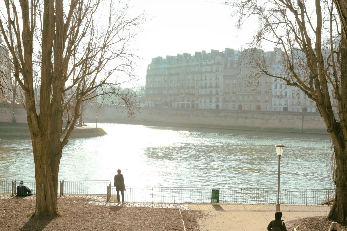 Pedestrians beside the Seine in Paris