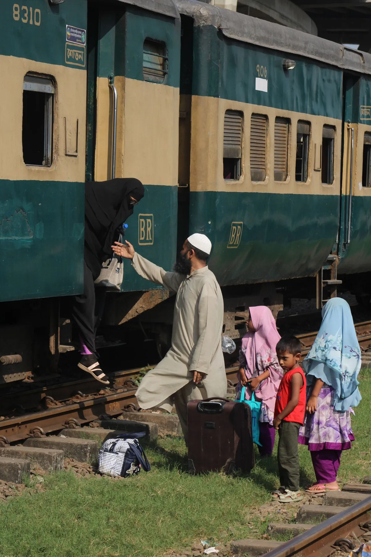 Passengers boarding a regional train at a rural station