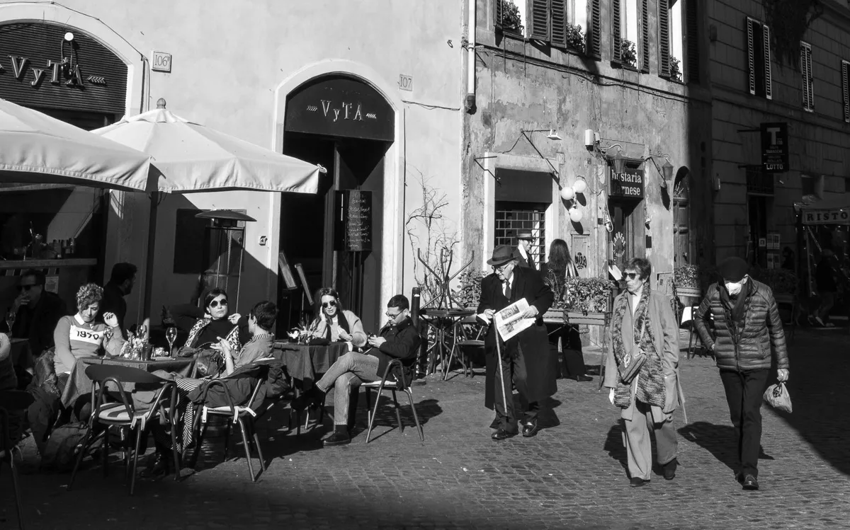 Outdoor tables and neighborhood street life in Rome