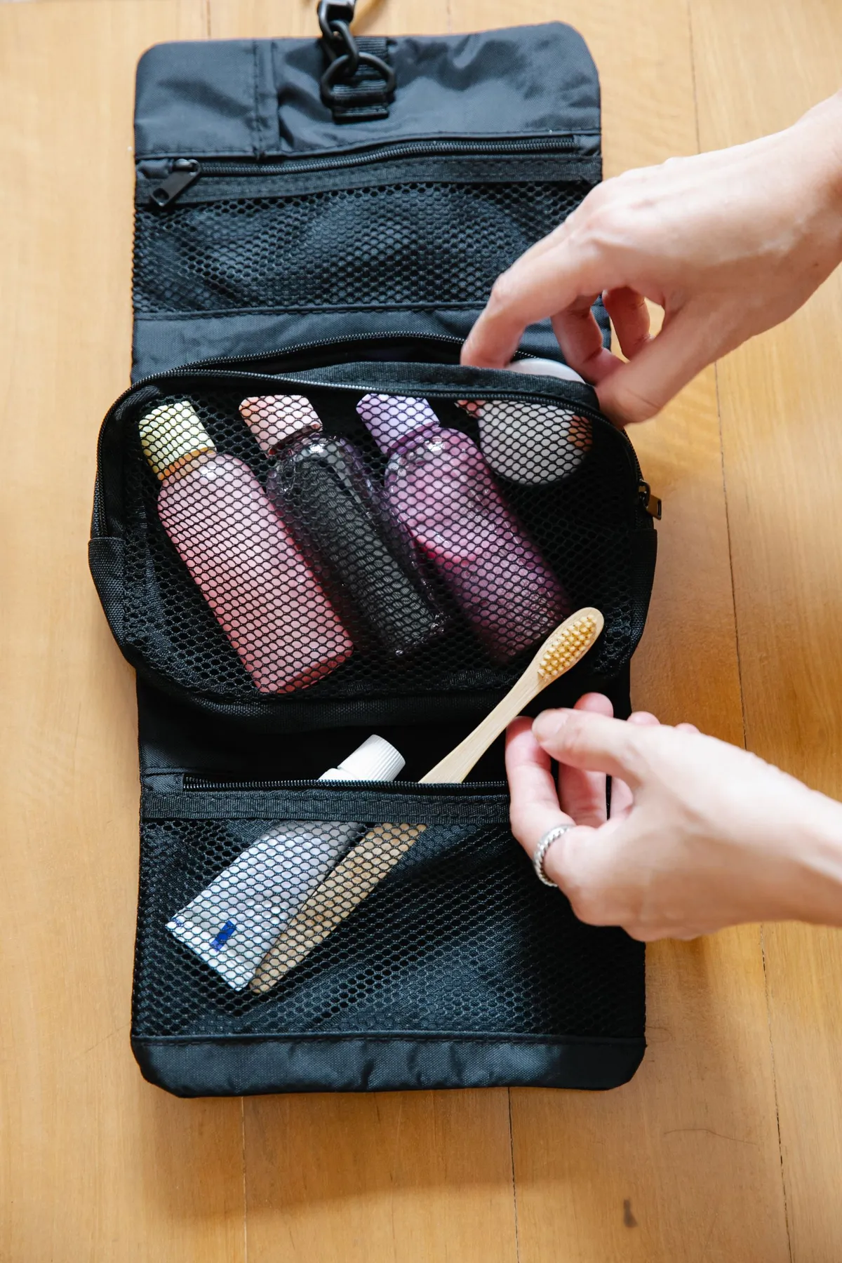 Open toiletry bag with bottles and a toothbrush