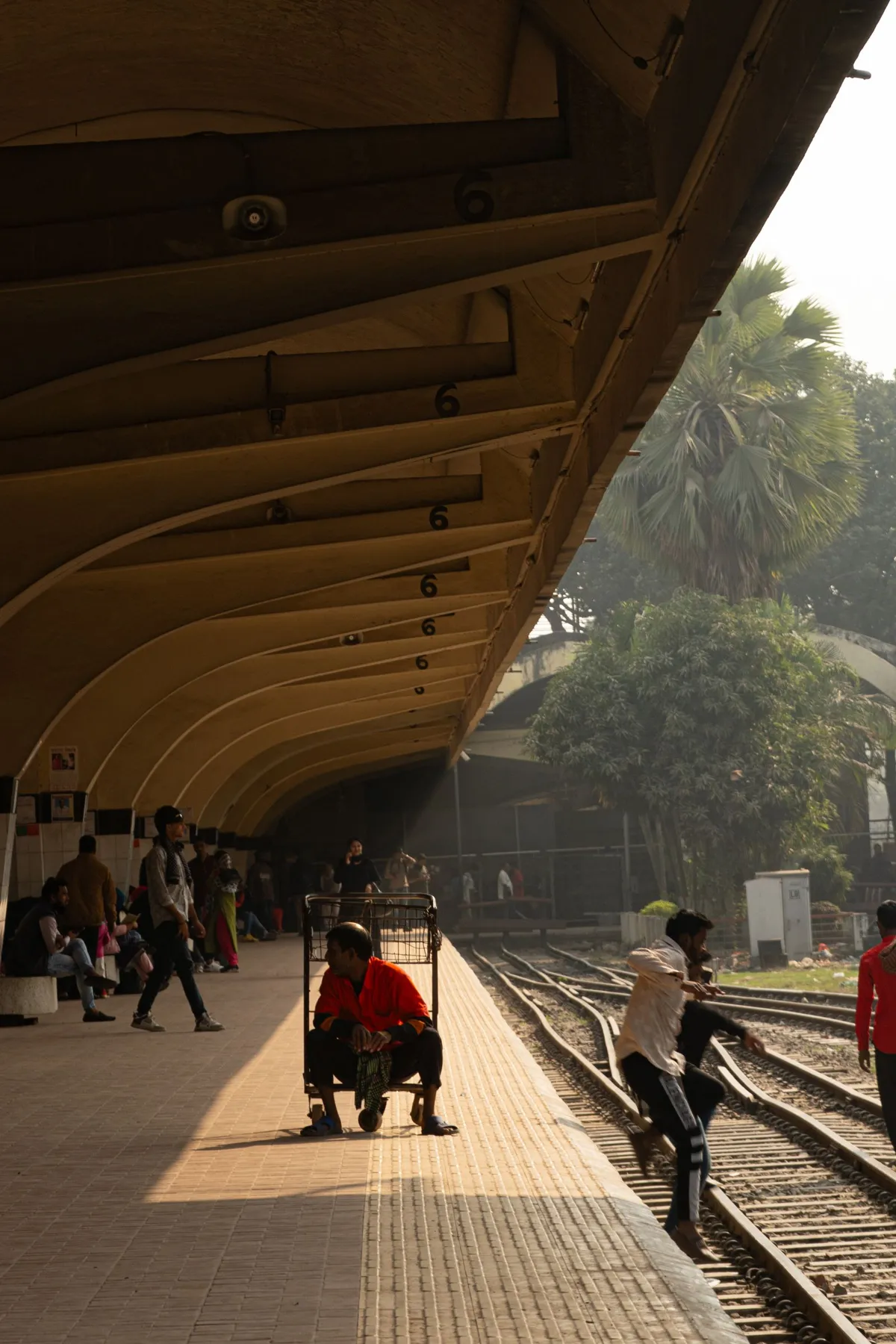 Travelers waiting beside trains on a station platform