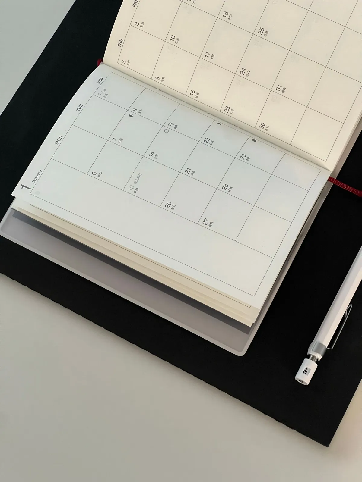 Calendar and notebook used for planning dates